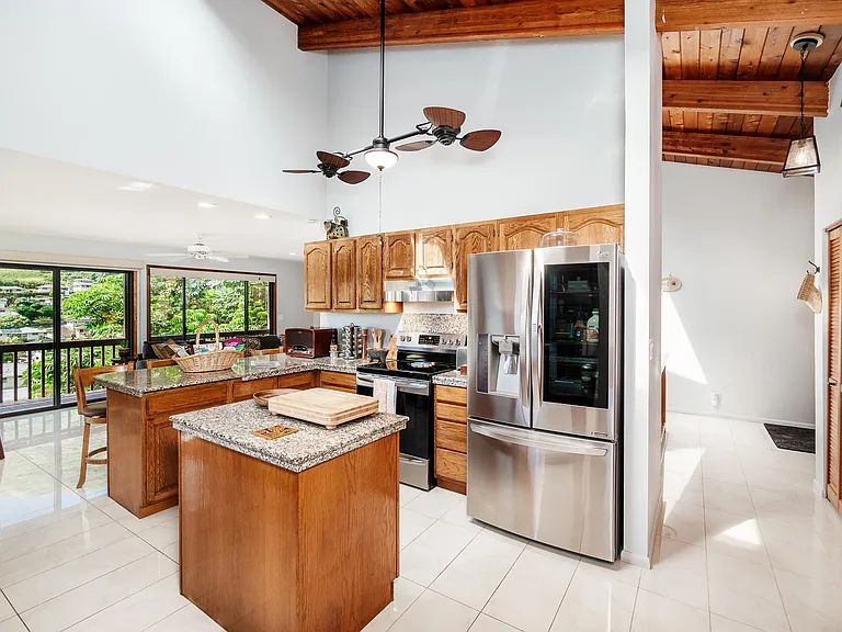beautiful kitchen with high end appliances, vaulted ceiling, double ceiling fan, open floor plan, lots of pantry space