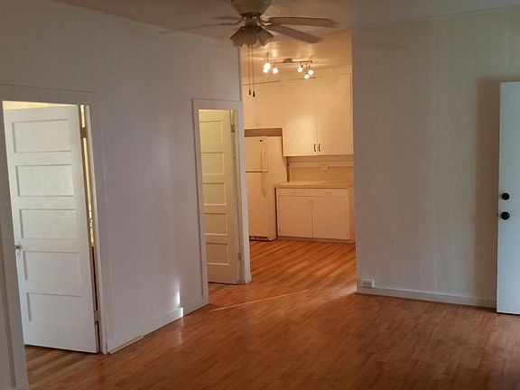 Living Room toward kitchen/ bed & bath on left/front door on