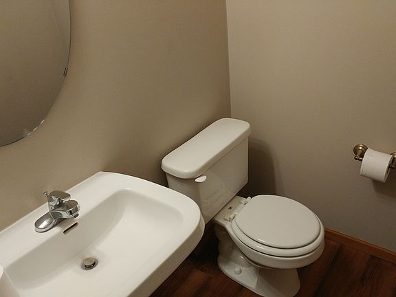 Lower level half bath with pedestal sink and new floors