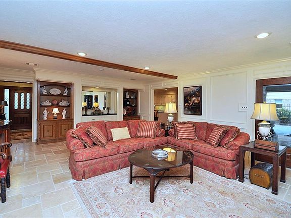 Notice the built-in cabinets and shelves. Side units left with vintage wood stain to coordinate with the beams across the ceiling. This room has a very light and airy feeling.