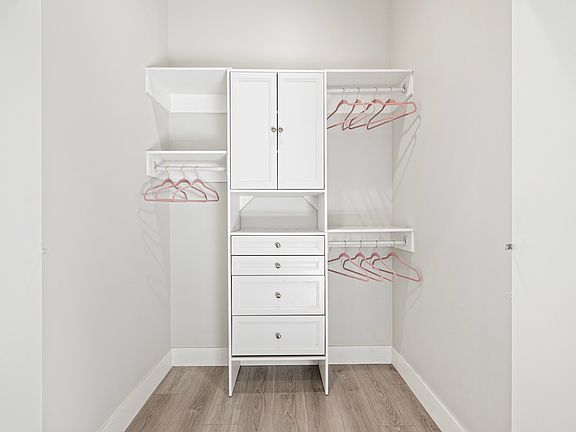 Step into luxury and organization with this full-size walk-in closet featuring beautifully organized cabinets. Your clothing and accessories deserve to be displayed in style!"