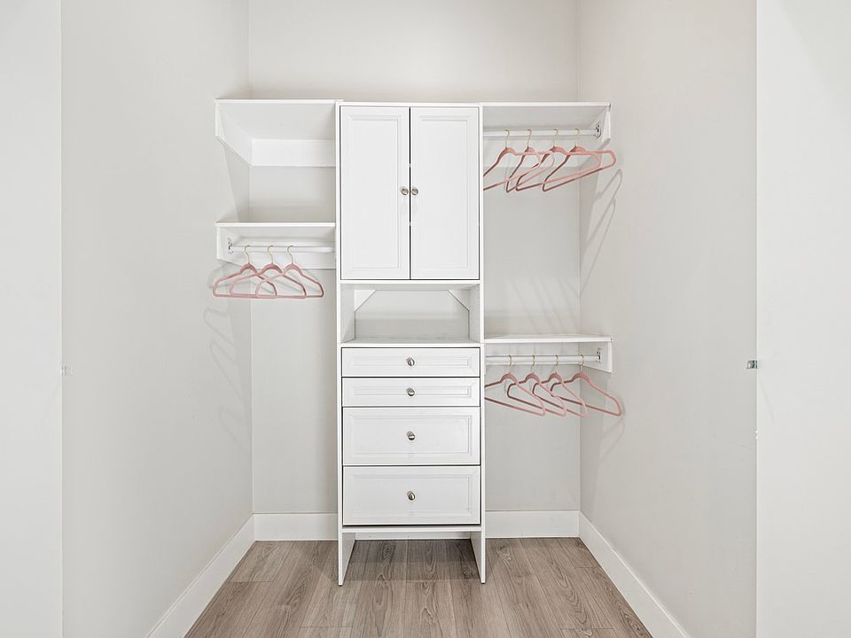 Step into luxury and organization with this full-size walk-in closet featuring beautifully organized cabinets. Your clothing and accessories deserve to be displayed in style!"