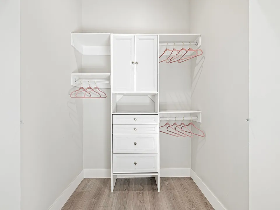 Step into luxury and organization with this full-size walk-in closet featuring beautifully organized cabinets. Your clothing and accessories deserve to be displayed in style!"