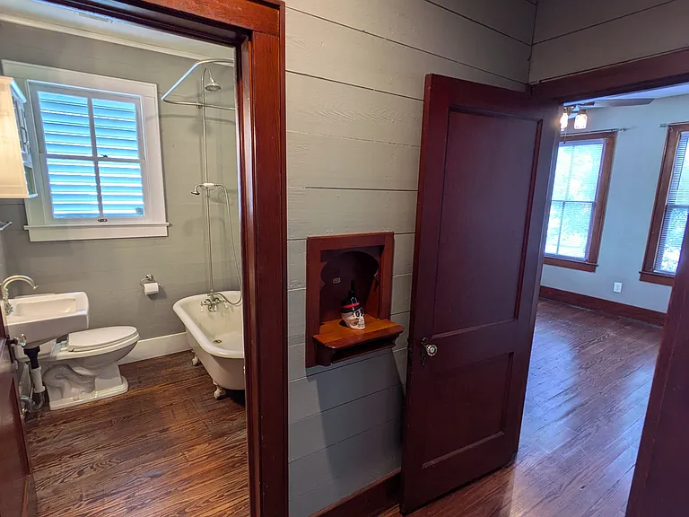 Hallway looking into bathroom and front bedroom.
