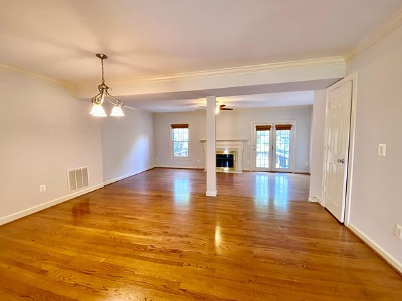 Living Room/Dining Room Combo w/ Hardwood Floor and Crown Molding. And A French Door Leading To A Spacious Deck.