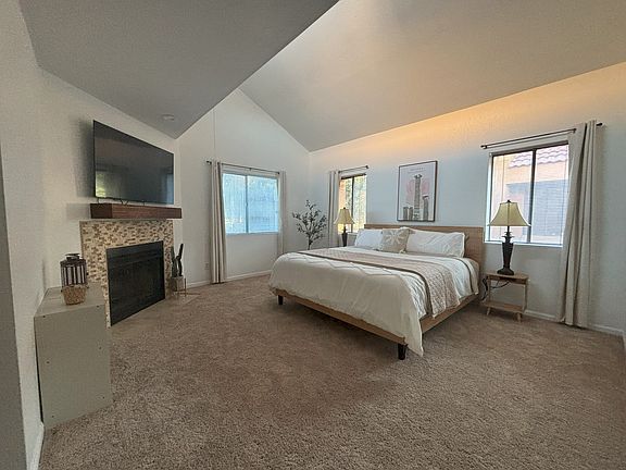Master bedroom with king bed, smart tv, walk in closet and en suite master bathroom