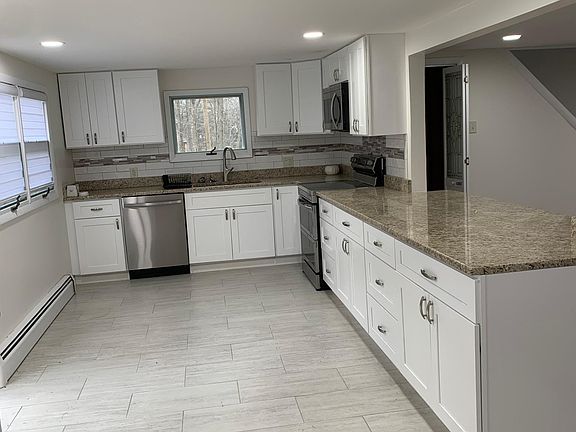 Brand new kitchen with granite countertops and island.
