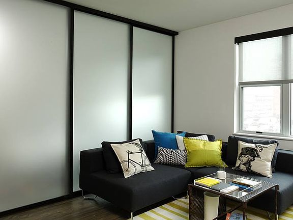 Living area with hard surface flooring and sliding barn door
