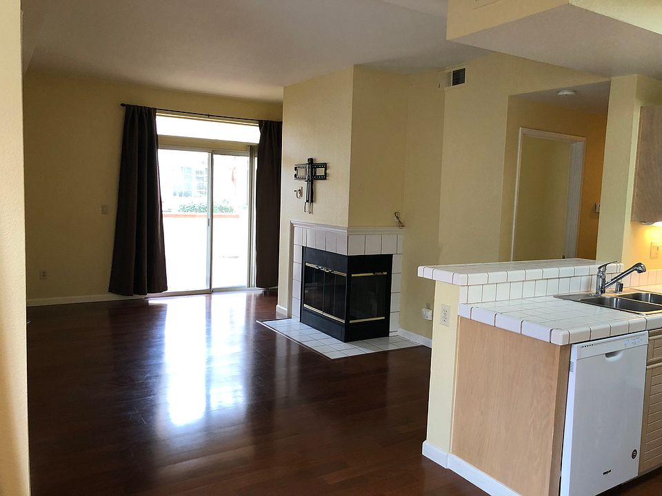 Living room and kitchen, unfurnished.