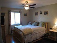 Master has attached bathroom.  View of forest.  Ceiling fan and walk-in closet