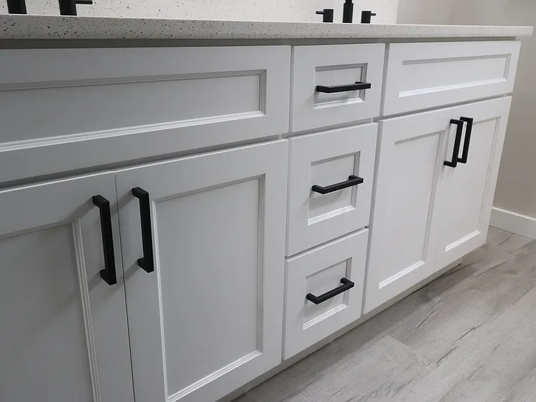 Spacious double vanity with modern black fixtures and plenty of storage.
