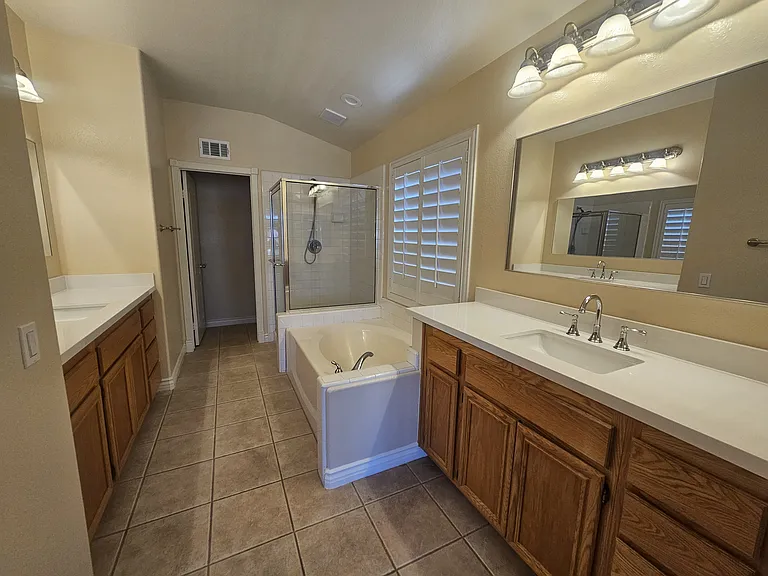 Master Bath with 2 separate sinks, tub and shower