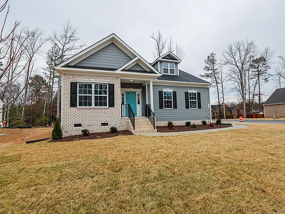 Gray and white house with a turquoise door and front steps-discover new homes in Richmond VA on a cl