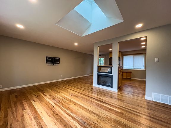 Open living/kitchen/dining area with tons of natural light
