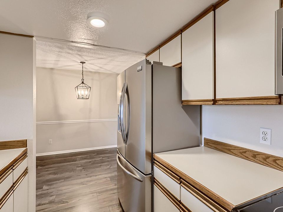View of Kitchen into Dining area that includes the spacious double door refrigerator.