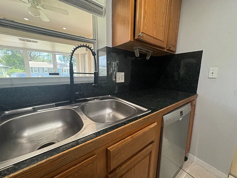 new kitchen faucet, stone counters & lighting from the front patio