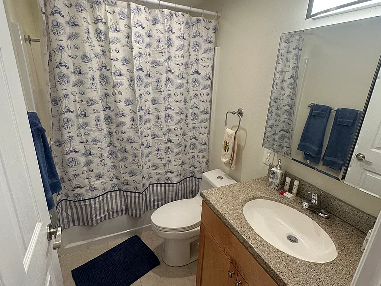 5' Tub shower, stylish one piece toilet. MEdicine cabinet with multiple mirror arrangement