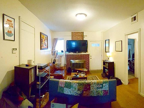 Living room, with dining room behind, coat closet left, fron