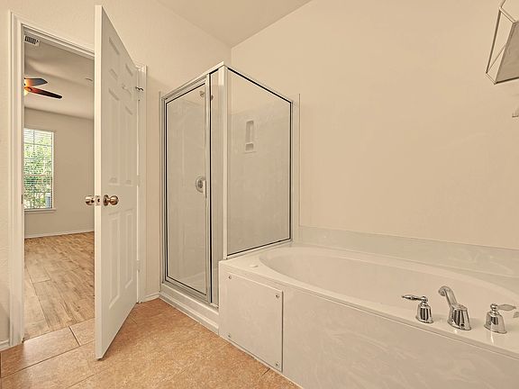 Master bath with separate shower and jetted tub