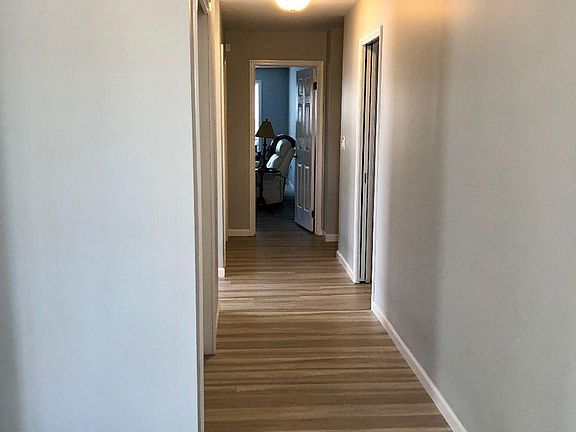 Entry foyer hallway with 2 closets, pantry and leads to a spacious 17' x 12' Den.