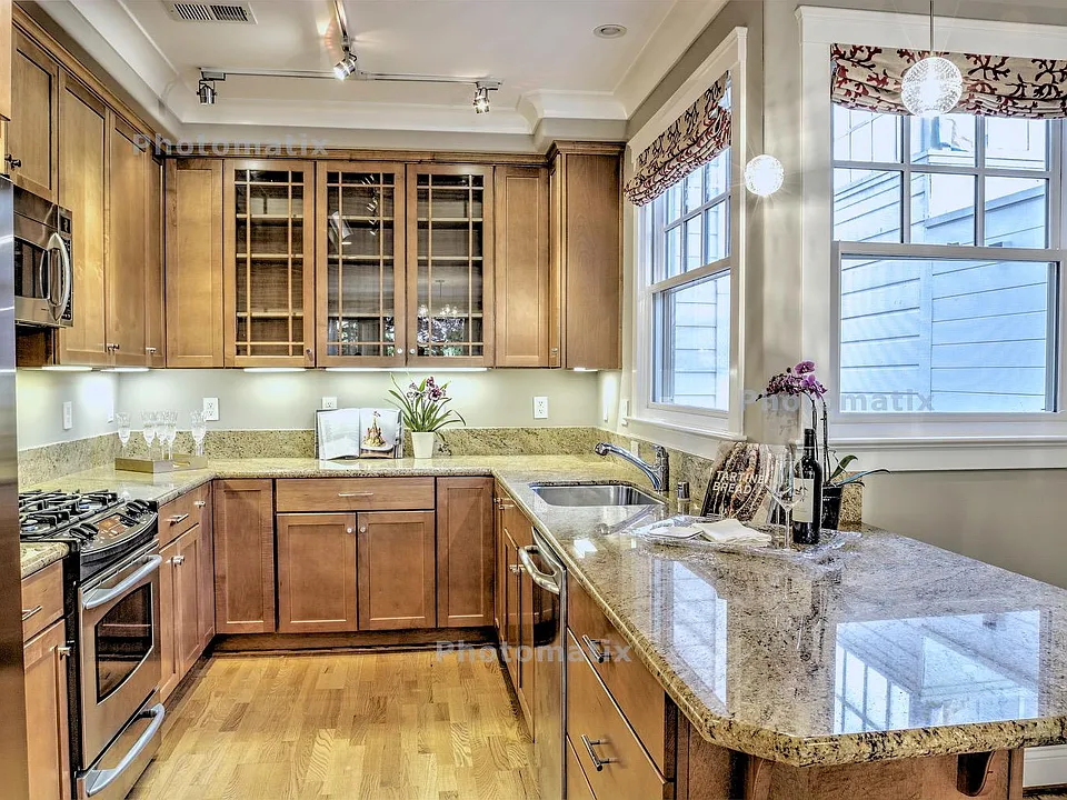 Open Kitchen with Granite countertops, pull out wood drawers, gas stove top, stainless steel appliances, kitchen island