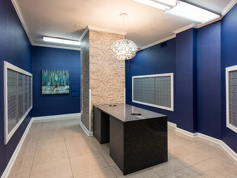 The River Place South building's mailroom. Separately, the concierge receives and processes notification of receipt for building residents.