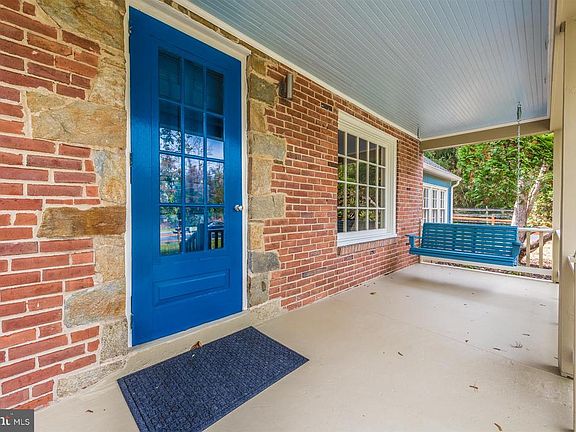 Brick front with stone detail around door.