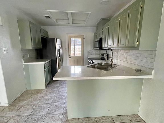 Kitchen newly renovated. Includes refrigerator, microwave, stove and oven. Door leads to backyard.