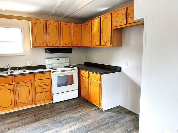 Kitchen. New refrigerator is being installed. Electric stove.
