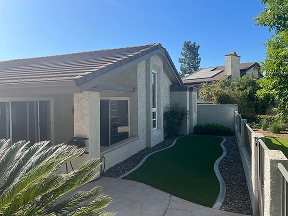 Rear yard access from the the master bedroom and living room areas; the gate leads to the community pool