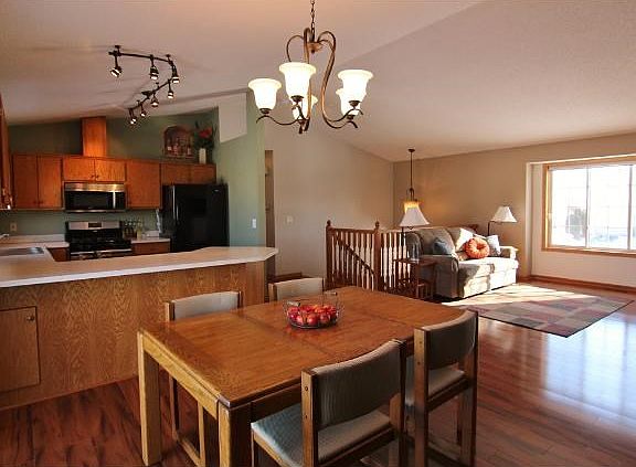 Dining and living rooms are vaulted and the living room boasts a warm corner fireplace...