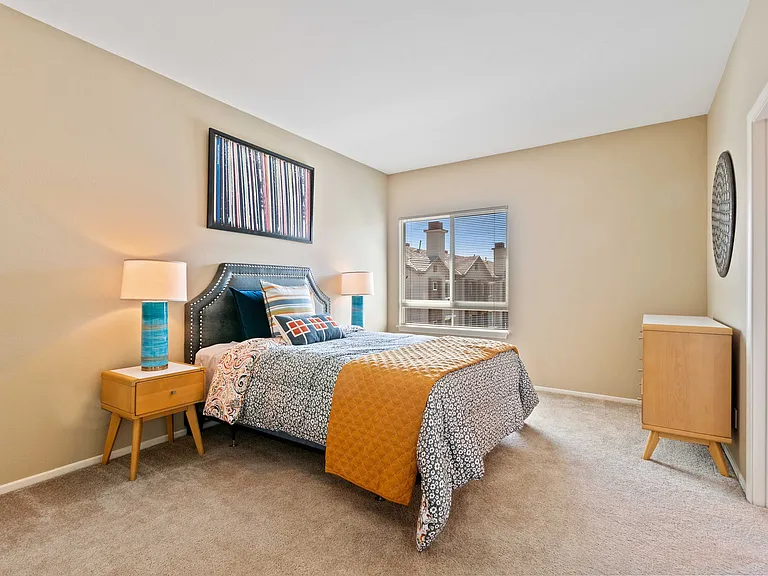 Spacious bedroom with a large window with beautiful views.