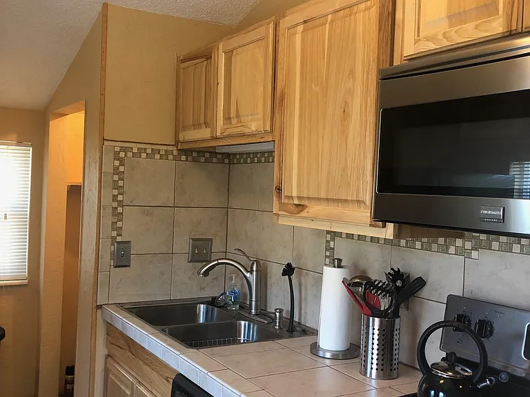Double sink with garbage disposal. Full sized washer and dryer located around the corner.