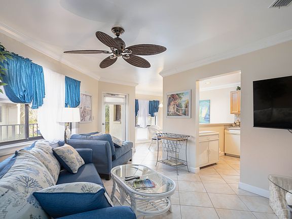 Main living room area. Open doorway on right leads into a large kitchen. Opening straight ahead leads to the dining room area.