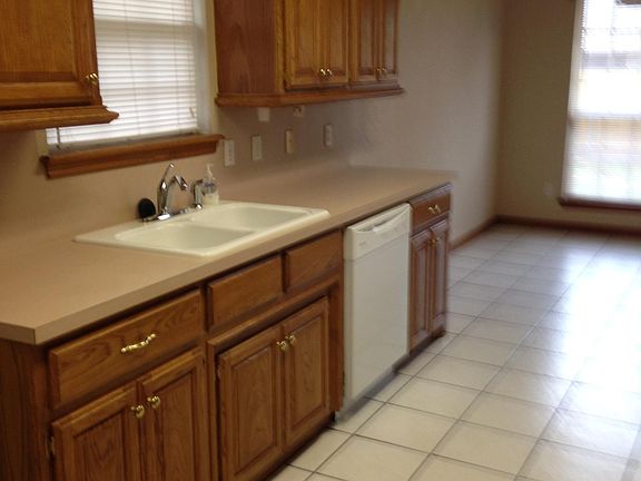 Kitchen with dish washer & tile flooring.
