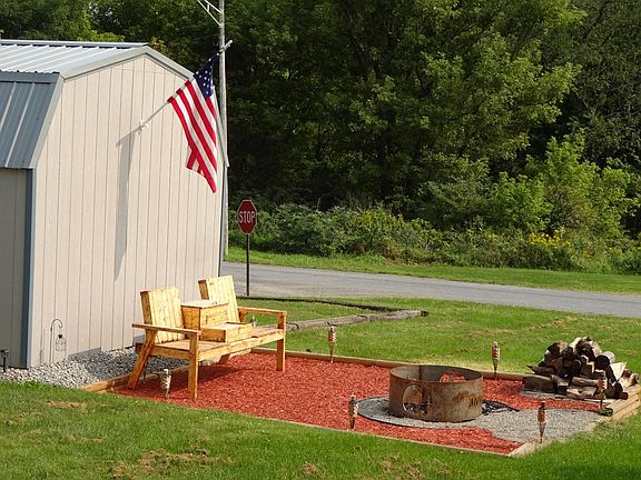 Common shared back area. Flag, seating, firepit, and wood are NOT supplied by landlord!