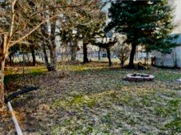 beautiful large fenced south facing backyard backing up to Valley City park fire pit, patio