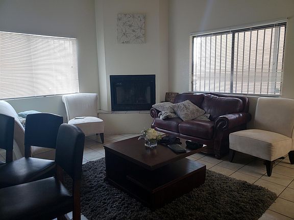 Wood burning fireplace and tall ceilings for a bright open living space.