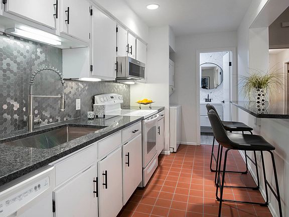 View of powder room and in unit washer and dryer