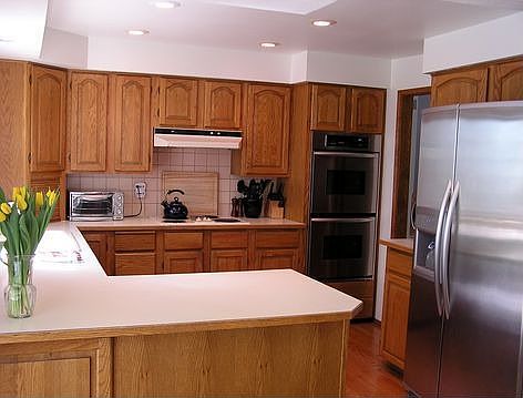 Open kitchen design with new ss appliances