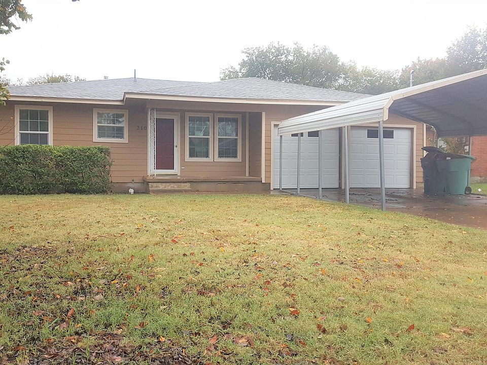 front of house. 2 car garage and carport. new roof, windows, and siding. small covered front porch area