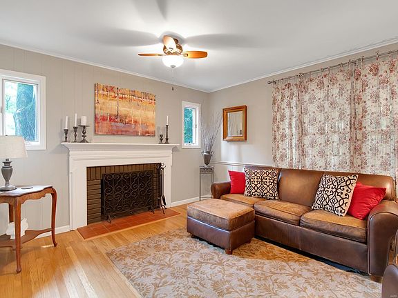 Family room adorned by a woodburning fireplace accented with unique side light windows.