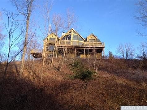 Looking up to the front wall of glass and expansive decks on this custom built, country contemporary.