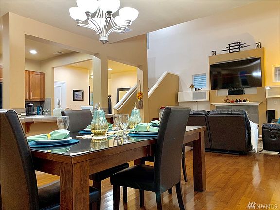 Amazing Open Floor Plan that allows you to see every part of the house. From the Fireplace looking into the kitchen and dining room area.  