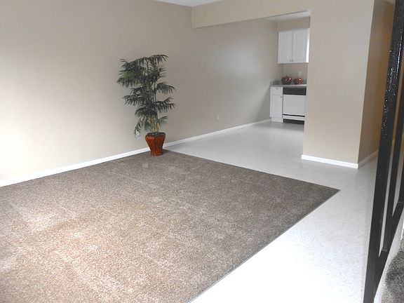 Living room with TV nook under stairs