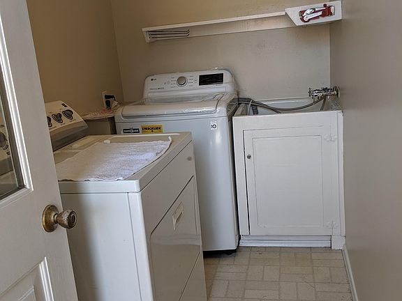 Laundry room with outside access and new washer/dryer plus laundry tub