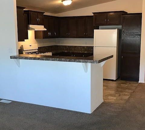 Modern cabinets with a darker finish complement this dream kitchen.  There's room for bar stools too.  The cook can be part of the fun with this open layout...
