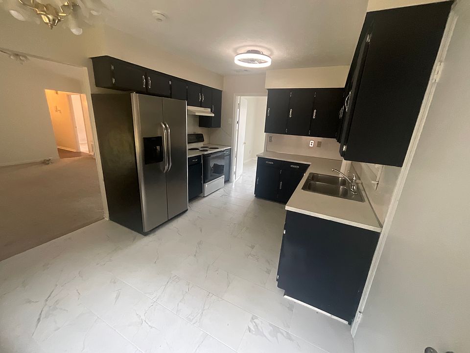 Cabinets are midnight blue. Matte ceramic tile floor.