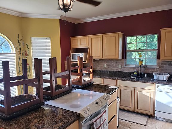 Kitchen, different view, and adjacent breakfast nook with complimentary wall mural.
