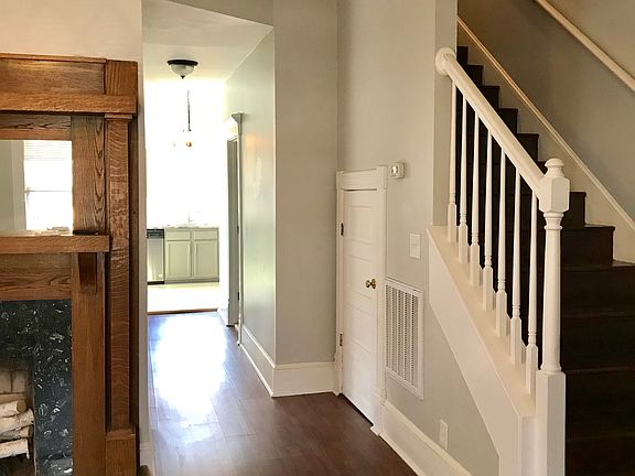 Living room with hallway to kitchen and upstairs
